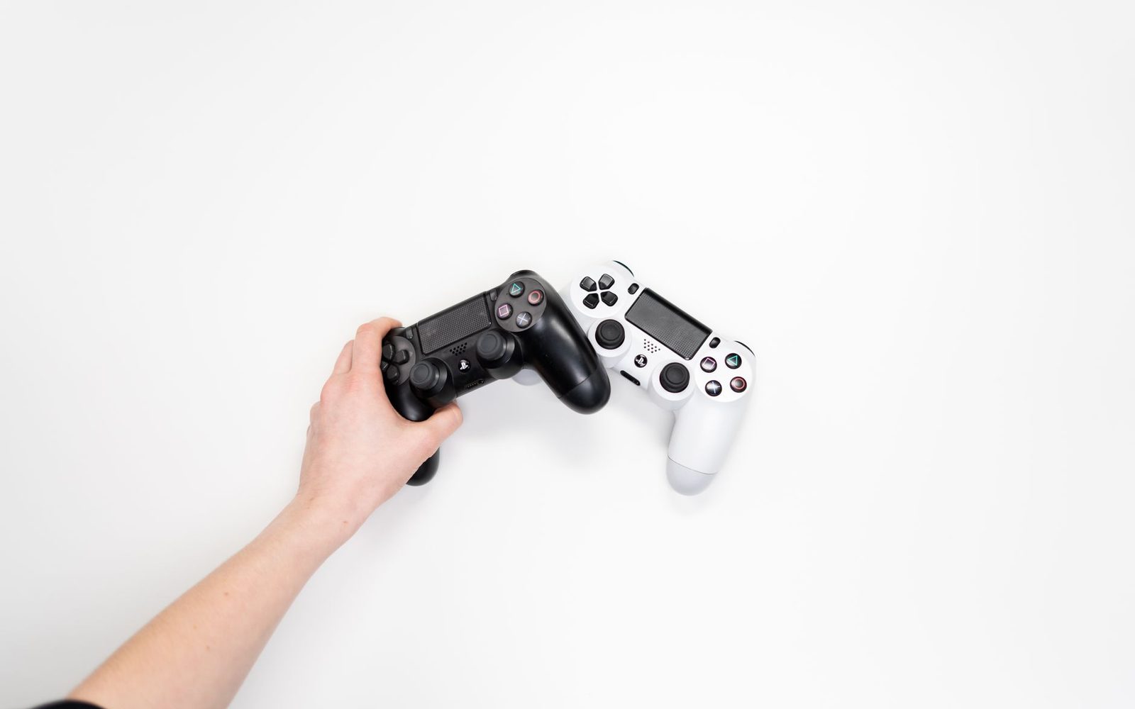 Player holding a game controller on a sofa